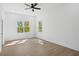 Bright bedroom featuring hardwood floors, a ceiling fan and two windows with natural light at 1882 Francis Nw Ave, Atlanta, GA 30318
