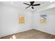 Bright, airy bedroom with hardwood floors, a ceiling fan, and windows looking out to the backyard at 1882 Francis Nw Ave, Atlanta, GA 30318
