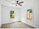 Bright, airy bedroom with hardwood floors, a ceiling fan, and windows looking out to the backyard at 1882 Francis Nw Ave, Atlanta, GA 30318