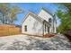 Bright white modern farmhouse-style home with black trim, concrete driveway and lush landscaping at 1882 Francis Nw Ave, Atlanta, GA 30318
