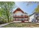 Beautiful two-story modern farmhouse with spacious wood balconies and well-kept lawn at 1882 Francis Nw Ave, Atlanta, GA 30318