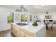 Open-concept kitchen island with marble countertops, modern fixtures, and stainless steel hood at 1882 Francis Nw Ave, Atlanta, GA 30318
