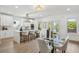 Gourmet kitchen and dining area with quartz countertops, white cabinetry, and modern appliances at 1882 Francis Nw Ave, Atlanta, GA 30318