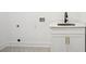 Laundry area with marble countertop, white cabinetry, and gold hardware at 1882 Francis Nw Ave, Atlanta, GA 30318