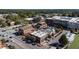 Aerial view of a neighborhood, highlighting commercial and residential buildings, tree-lined streets, and a bustling atmosphere at 284 Hook St, Alpharetta, GA 30009