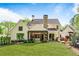 Expansive backyard featuring a covered patio, lush lawn, and meticulously landscaped garden areas at 284 Hook St, Alpharetta, GA 30009