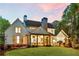 Back exterior of a home with a covered patio, outdoor grill area, and well-maintained lawn at 284 Hook St, Alpharetta, GA 30009