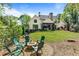 Inviting backyard features a fire pit with seating, lush lawn, and mature trees for privacy at 284 Hook St, Alpharetta, GA 30009
