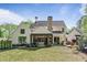 Spacious backyard with lush lawn, custom patio, and a view of the house at 284 Hook St, Alpharetta, GA 30009