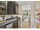 Chic bar area featuring a wine rack, beverage fridge, sleek countertop, and open access to the dining room at 284 Hook St, Alpharetta, GA 30009