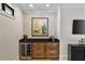 Entertainment area with a wine fridge, a dry bar, and decorative stone wall at 284 Hook St, Alpharetta, GA 30009