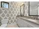Bathroom featuring leaf-patterned wallpaper, undermount sinks, and a glass shower at 284 Hook St, Alpharetta, GA 30009