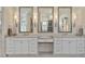 Bright bathroom featuring double vanity, decorative mirrors, marble counters, and sconce lighting at 284 Hook St, Alpharetta, GA 30009