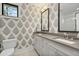 Stylish bathroom featuring patterned wallpaper, dual sinks, and modern fixtures at 284 Hook St, Alpharetta, GA 30009