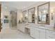 Bright bathroom featuring double vanity, decorative mirrors, marble counters, and a glass-enclosed shower at 284 Hook St, Alpharetta, GA 30009