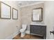 Chic powder room with decorative mirror, stylish vanity, and modern toilet for a sophisticated guest experience at 284 Hook St, Alpharetta, GA 30009