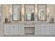 Elegant bathroom featuring dual vanities, decorative mirrors, and sconce lighting at 284 Hook St, Alpharetta, GA 30009