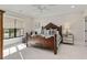 Sun-lit bedroom featuring a decorative bedframe, sitting area, and large window at 284 Hook St, Alpharetta, GA 30009