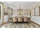 Formal dining room with an elegant chandelier, neutral walls, and a large table set for a dinner party at 284 Hook St, Alpharetta, GA 30009