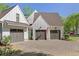 Exterior view of the home featuring a three-car garage, modern farmhouse style, and well-maintained landscaping at 284 Hook St, Alpharetta, GA 30009