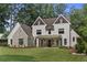Stately home with manicured lawn, covered porch, and brick accents offering timeless appeal at 284 Hook St, Alpharetta, GA 30009