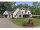 Elegant home with beautiful landscaping, a charming front porch, and a well-maintained lawn at 284 Hook St, Alpharetta, GA 30009