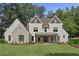 Beautiful two-story home featuring white siding, decorative gables, and a welcoming front porch with rocking chairs at 284 Hook St, Alpharetta, GA 30009