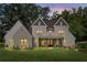 Twilight view of a charming two-story home with a welcoming front porch and well-manicured lawn at 284 Hook St, Alpharetta, GA 30009