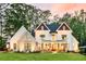 Inviting two-story home featuring a well-manicured lawn and a charming front porch with rocking chairs at 284 Hook St, Alpharetta, GA 30009