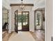 Welcoming foyer featuring a glass-paneled front door and views into adjacent rooms with hardwood floors at 284 Hook St, Alpharetta, GA 30009