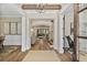 Elegant foyer with hardwood floors, decorative rug, chandelier, white wainscoting, and a view into the living room at 284 Hook St, Alpharetta, GA 30009
