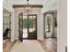 Bright foyer featuring hardwood floors, a statement chandelier, an open front door and a view into the front yard at 284 Hook St, Alpharetta, GA 30009