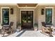 A welcoming front entrance features a brick porch, rocking chairs, potted plants, and elegant lighting fixtures at 284 Hook St, Alpharetta, GA 30009