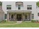 Inviting front porch features classic rocking chairs and hanging plants, perfect for enjoying the outdoors at 284 Hook St, Alpharetta, GA 30009