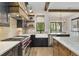Well-appointed kitchen with a farmhouse sink, Wolf range, and granite countertops at 284 Hook St, Alpharetta, GA 30009