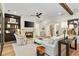 Bright living room with fireplace, tv, wood beams, and large windows with comfortable furnishings at 284 Hook St, Alpharetta, GA 30009