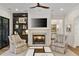 Inviting living room with a stone fireplace, comfortable seating, built-in bookshelves, and neutral decor at 284 Hook St, Alpharetta, GA 30009