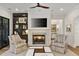 Cozy living room featuring a fireplace, built-in shelving, and comfortable seating for relaxation and entertainment at 284 Hook St, Alpharetta, GA 30009