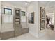 Luxurious main bathroom featuring dual vanities, a walk-in shower, and a separate area with built-in storage at 284 Hook St, Alpharetta, GA 30009
