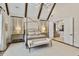 Airy main bedroom with a stylish bed, side tables, bench and large windows offering ample natural light at 284 Hook St, Alpharetta, GA 30009