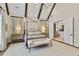 Stunning main bedroom with vaulted ceilings, wood beams, neutral decor, and an abundance of natural light at 284 Hook St, Alpharetta, GA 30009