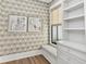Stylish office with patterned wallpaper, window seat, and built-in shelving for organization and a bright workspace at 284 Hook St, Alpharetta, GA 30009