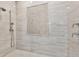 Elegant shower featuring a mosaic accent tile, rainfall showerhead, and marble surround at 284 Hook St, Alpharetta, GA 30009