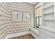 Bright sitting area with decorative wallpaper, built in bookshelves and drawers, and a cushioned window seat at 284 Hook St, Alpharetta, GA 30009