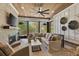 Relaxing sunroom with brick fireplace, comfortable seating, and large windows with natural light and views at 284 Hook St, Alpharetta, GA 30009