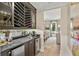 Elegant wine bar featuring custom shelving, a mirrored backsplash, and a convenient beverage cooler at 284 Hook St, Alpharetta, GA 30009
