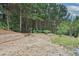 Large backyard featuring mature trees and landscaping at 486 Crestmont Ln, Canton, GA 30114