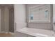Modern bathroom featuring a shower, soaking tub, and tiled walls at 486 Crestmont Ln, Canton, GA 30114