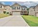 Charming two-story home features a stone facade, attached garage and well maintained lawn at 486 Crestmont Ln, Canton, GA 30114