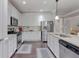 Modern kitchen with stainless steel appliances, white cabinetry, and granite countertops at 486 Crestmont Ln, Canton, GA 30114